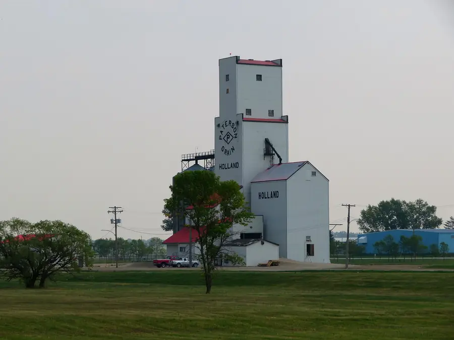 Grain elevator beside an open field on the Manitoba prairie